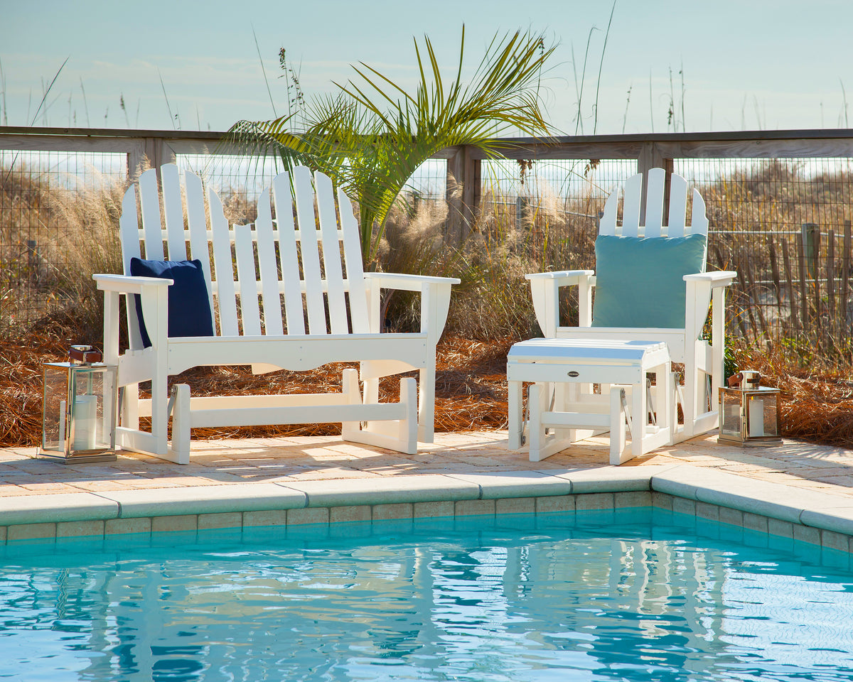 POLYWOOD Classic Adirondack Glider Chair in White in an outdoor setting