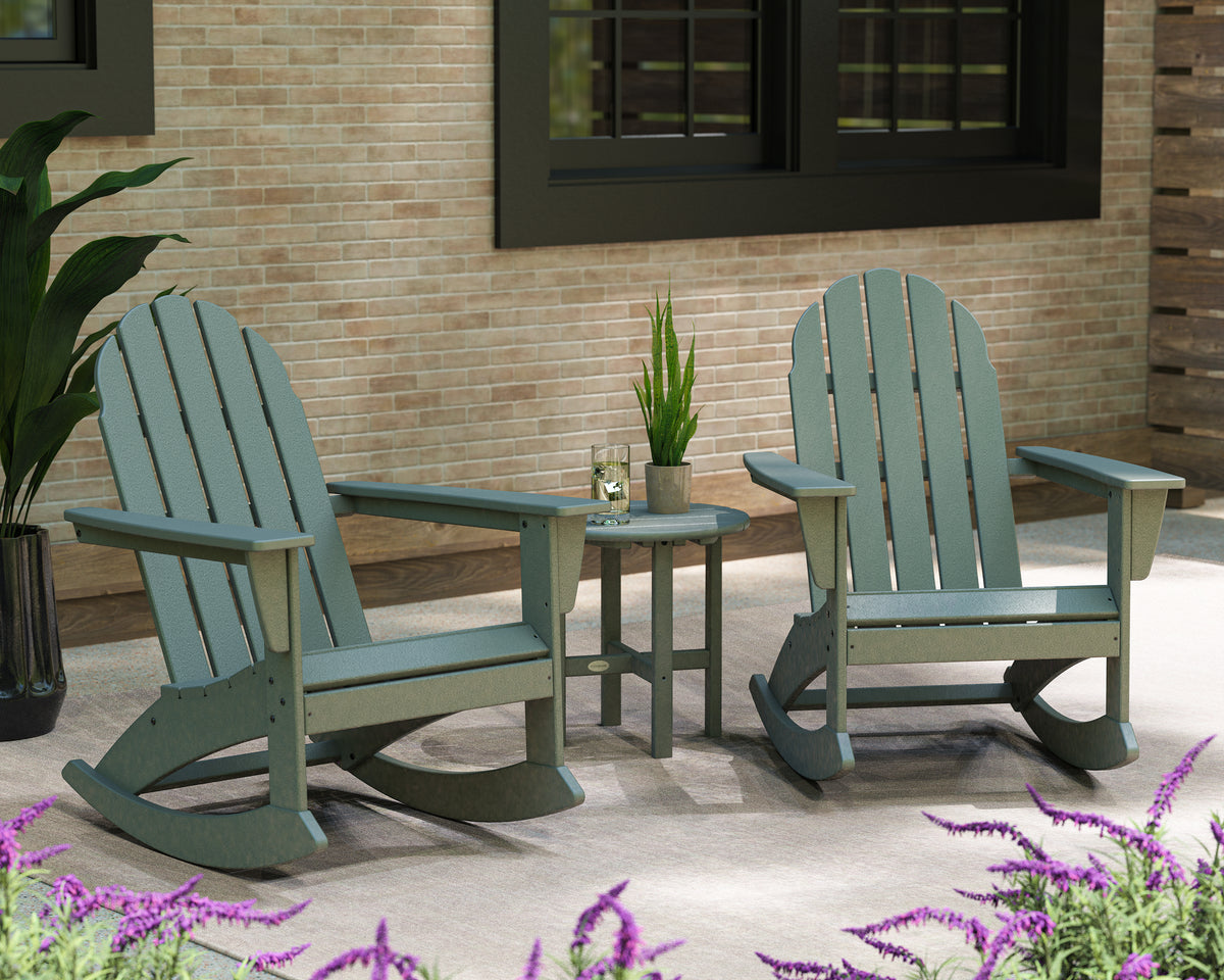 Lifestyle photo of the POLYWOOD Vineyard 3-Piece Adirondack Rocking Chair Set with 18" Round Table in Slate Grey