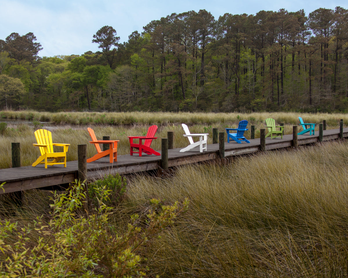 Lifestyle photo of the POLYWOOD Palm Coast Adirondack Chair