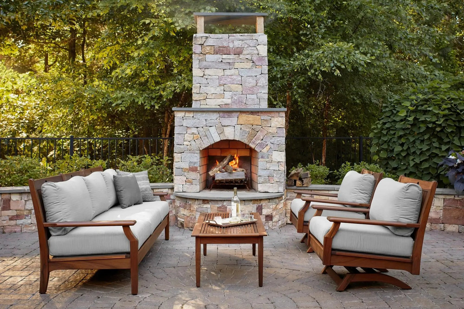 Create the perfect outdoor ambiance with a cozy patio featuring a fireplace and stylish furniture.