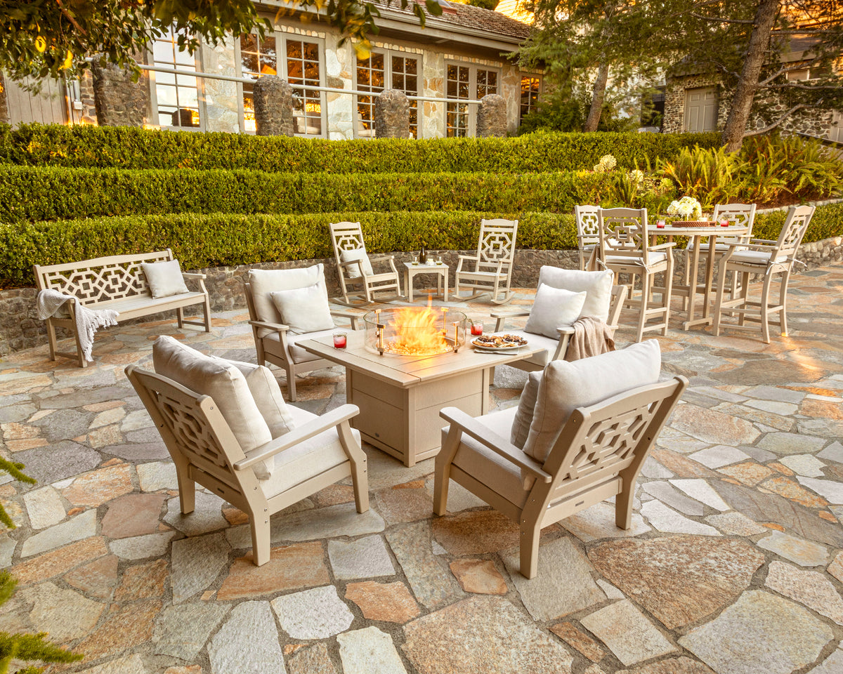 POLYWOOD Chinoiserie Bar Arm Chair in Sand in an outdoor setting