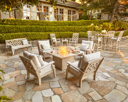 POLYWOOD Chinoiserie Bar Arm Chair in Sand in an outdoor setting