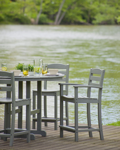 POLYWOOD La Casa Café Counter Arm Chair in Slate Grey in an outdoor setting