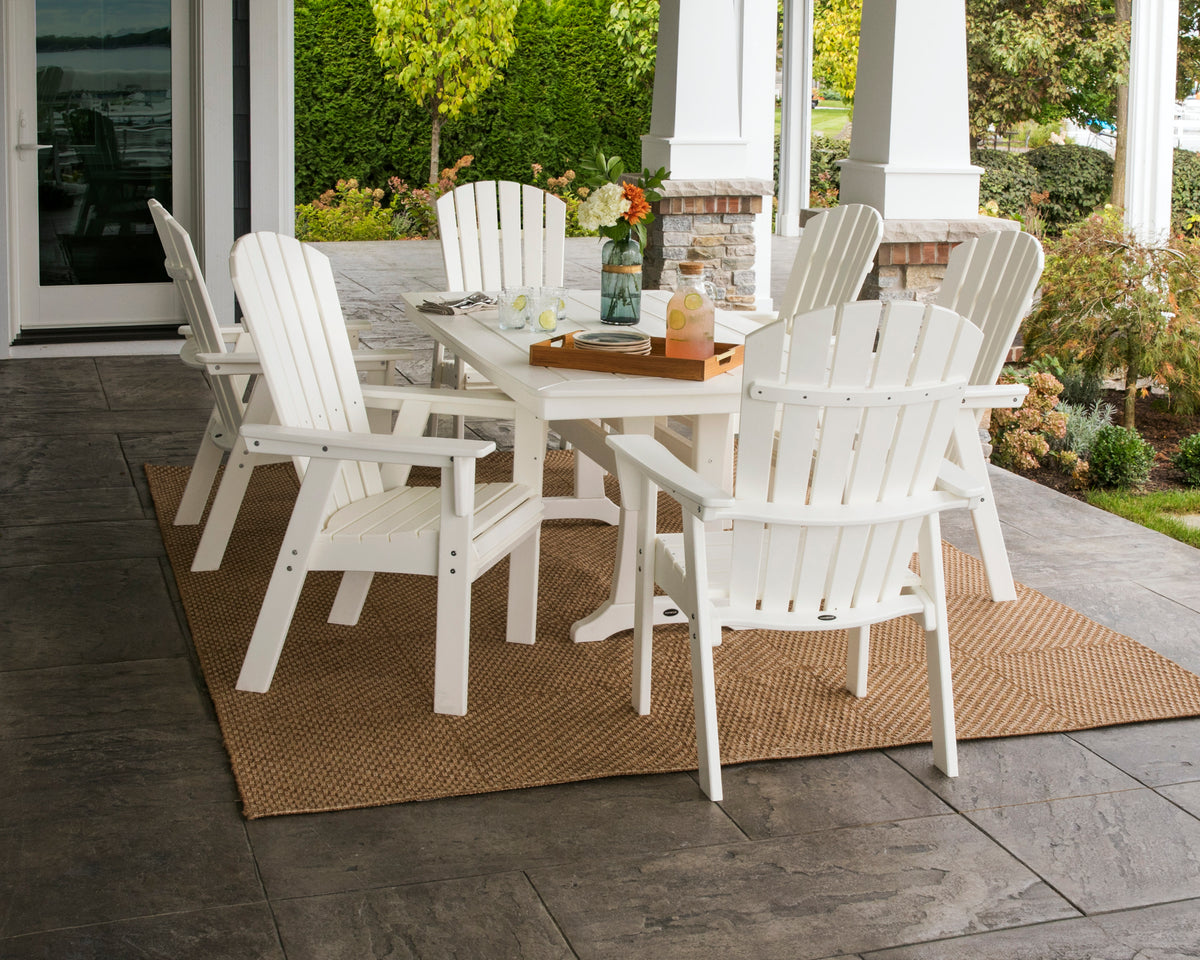 Lifestyle photo of the POLYWOOD Nautical Curveback Adirondack 7-Piece Dining Set with Trestle Legs