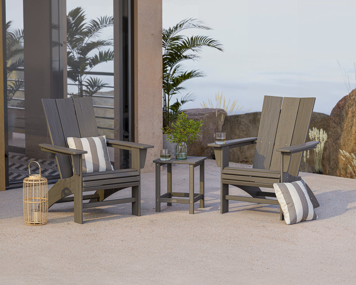 Lifestyle photo of the POLYWOOD Modern 3-Piece Curveback Adirondack Set With Long Island 18" Side Table in Driftwood