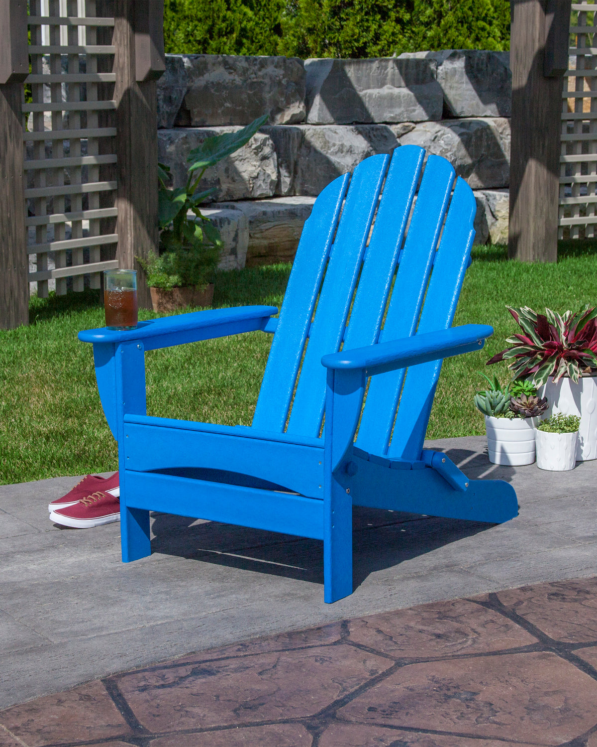 POLYWOOD Classic Oversized Folding Adirondack Chair in Pacific Blue in an outdoor setting