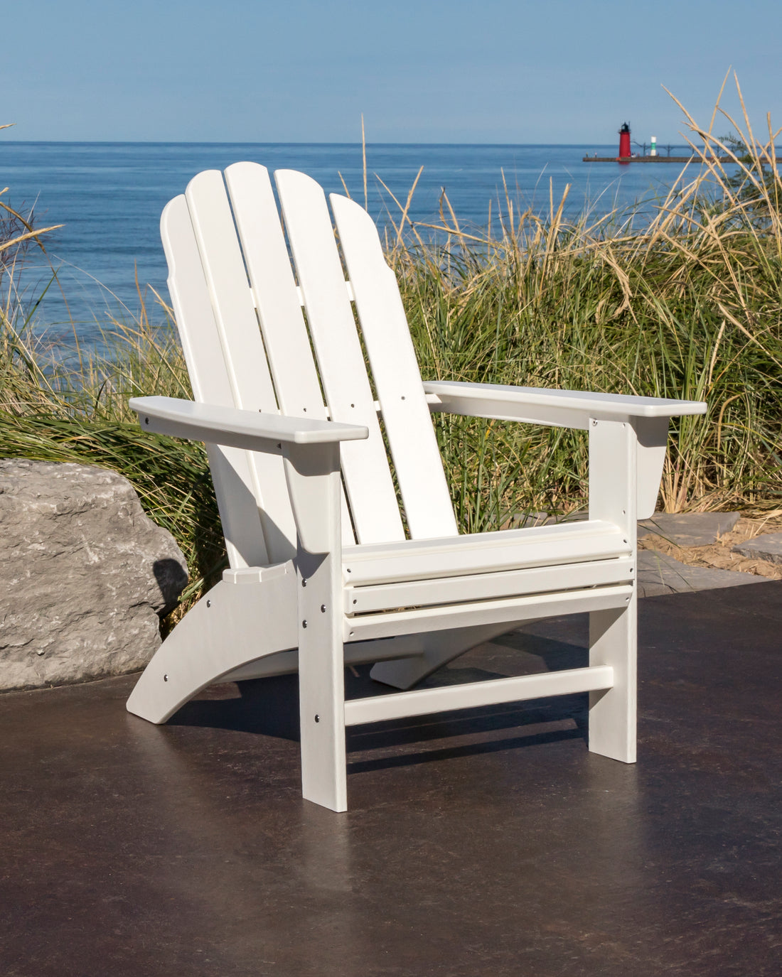 POLYWOOD Vineyard Curveback Adirondack Chair in White in an outdoor setting