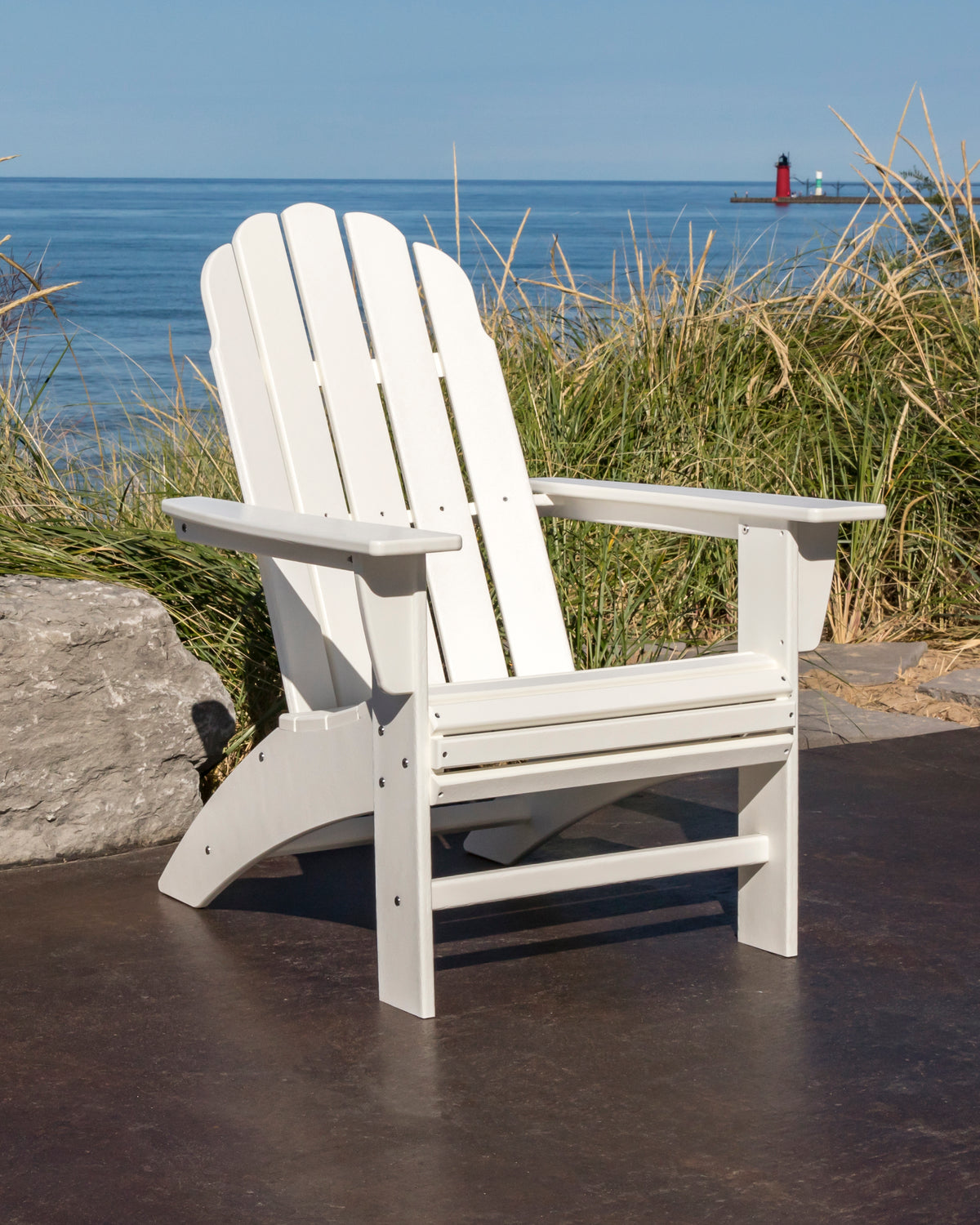 POLYWOOD Vineyard Curveback Adirondack Chair in White in an outdoor setting