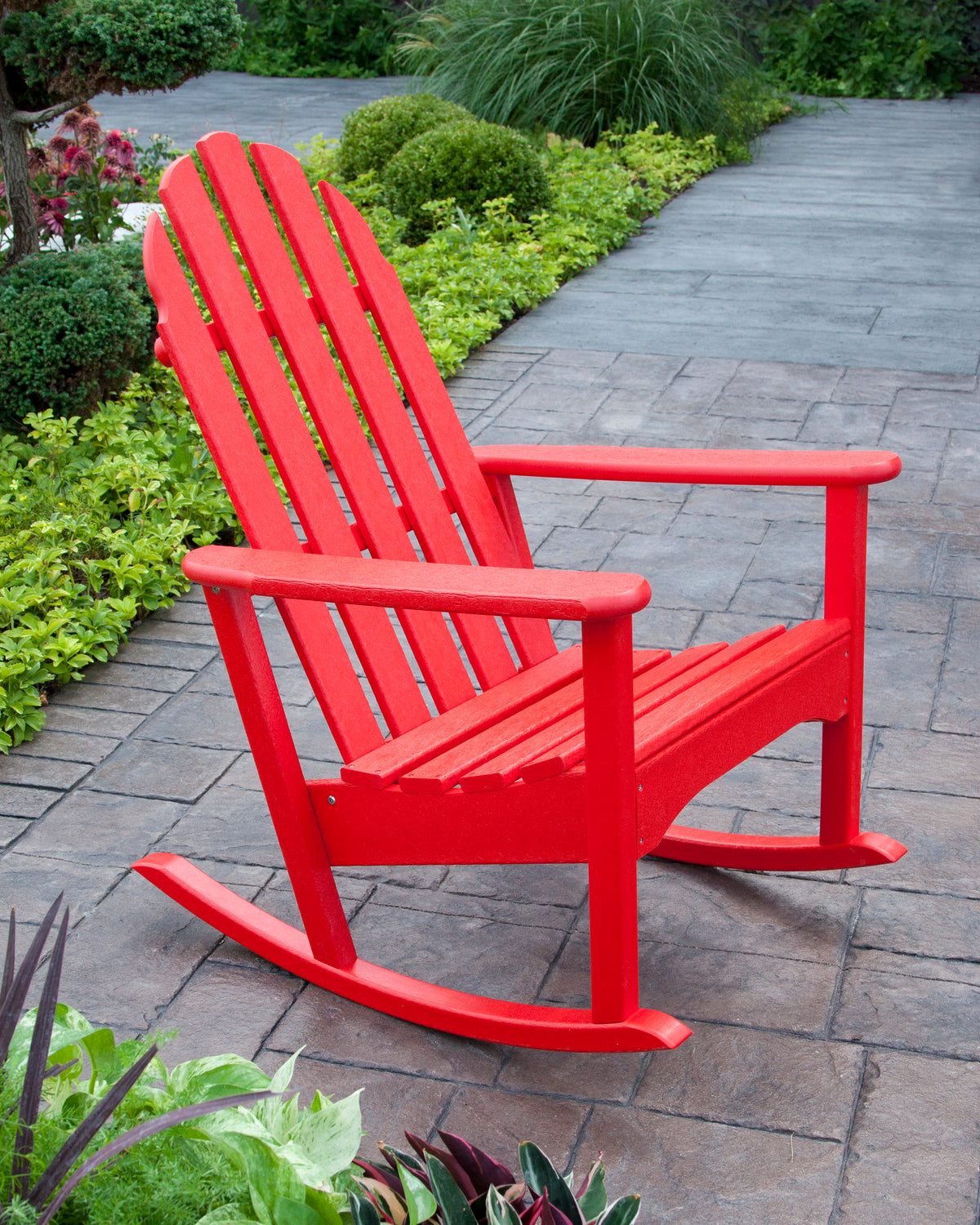 POLYWOOD Classic Adirondack Rocking Chair in Sunset Red in an outdoor setting