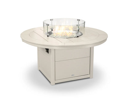 Round outdoor fire table with glass top on a white background