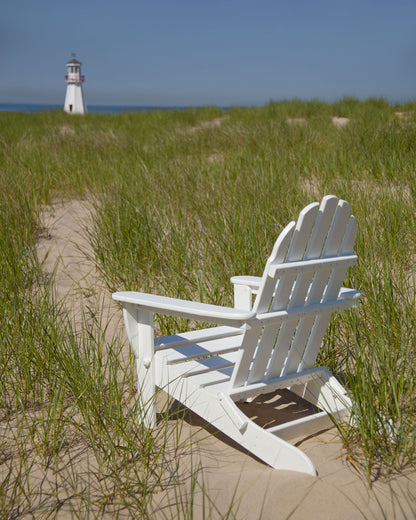 Lifestyle photo of the POLYWOOD Classic Folding Adirondack Chair in White