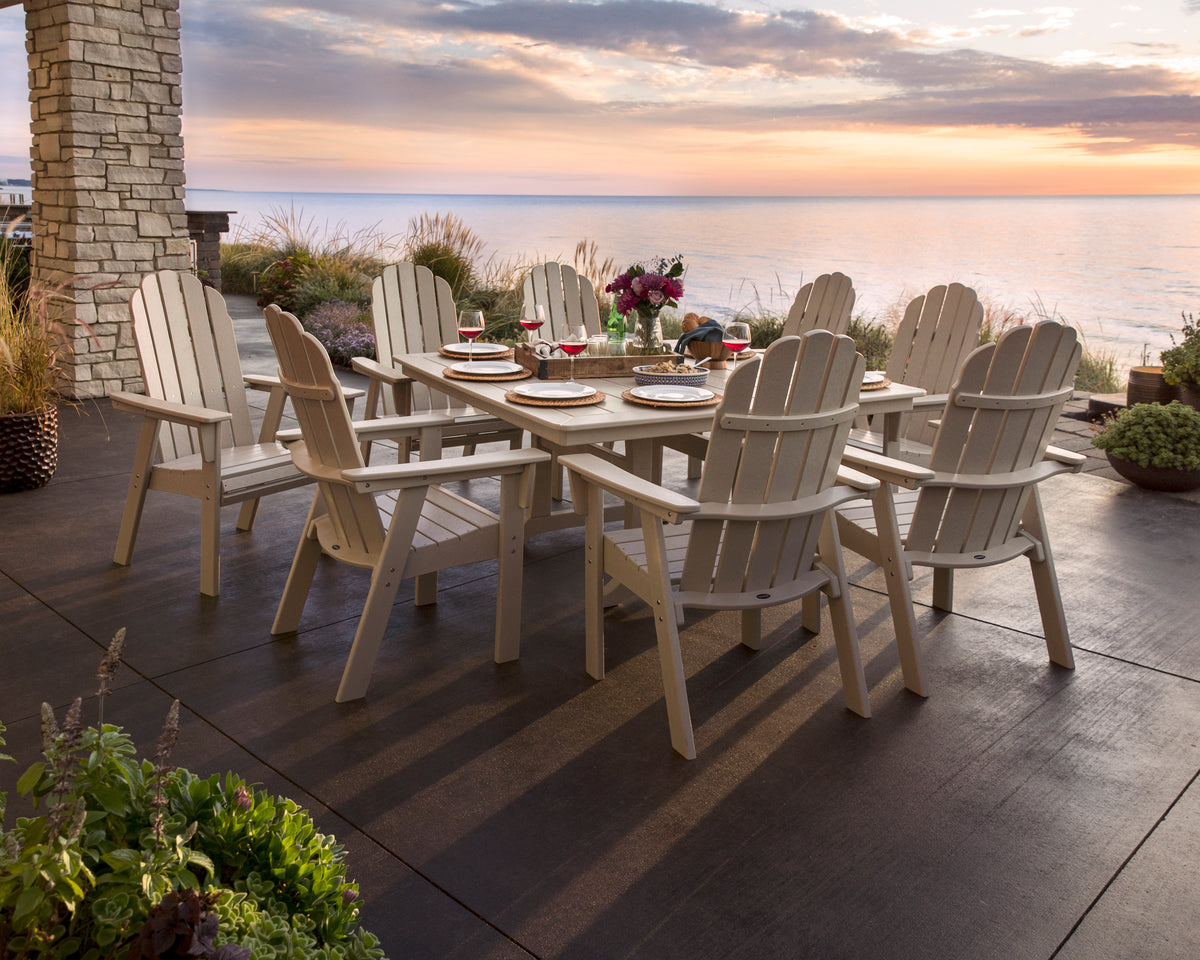 POLYWOOD Vineyard Curveback Adirondack Dining Chair in Sand in an outdoor setting