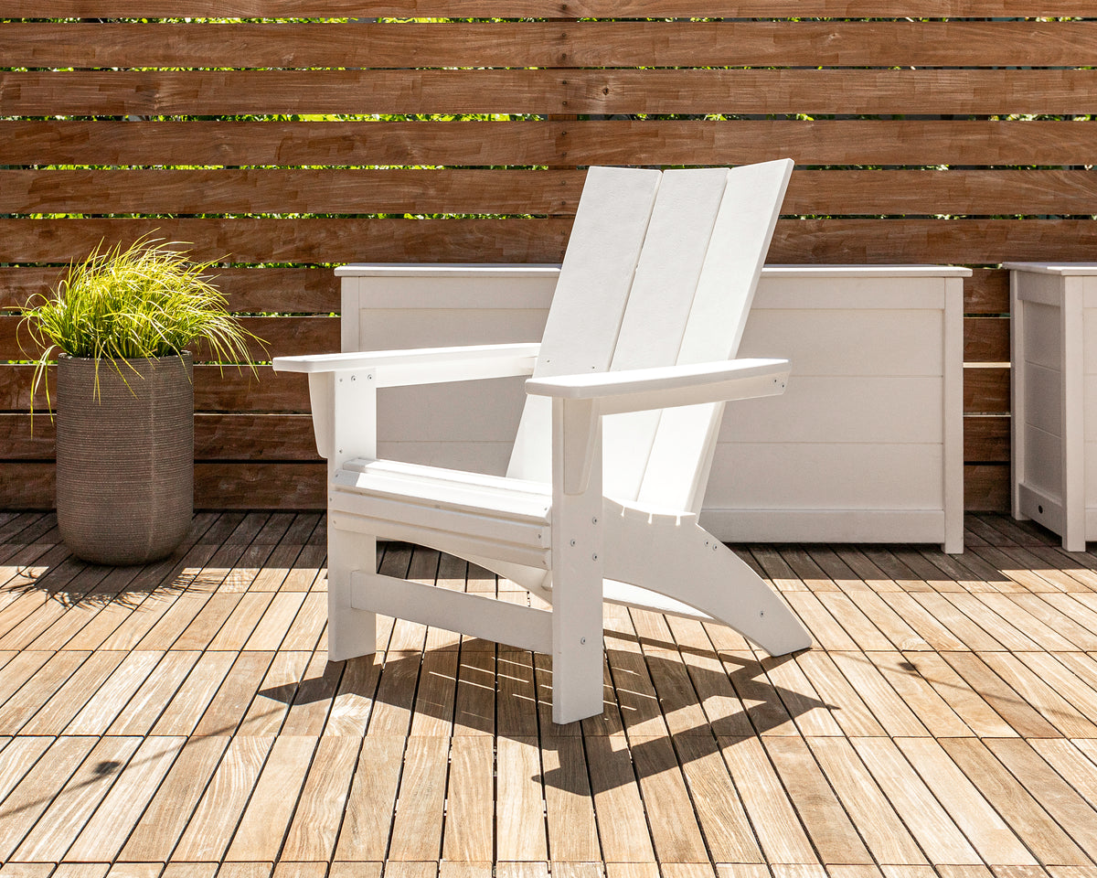 POLYWOOD Modern Grand Adirondack Chair in White in an outdoor setting