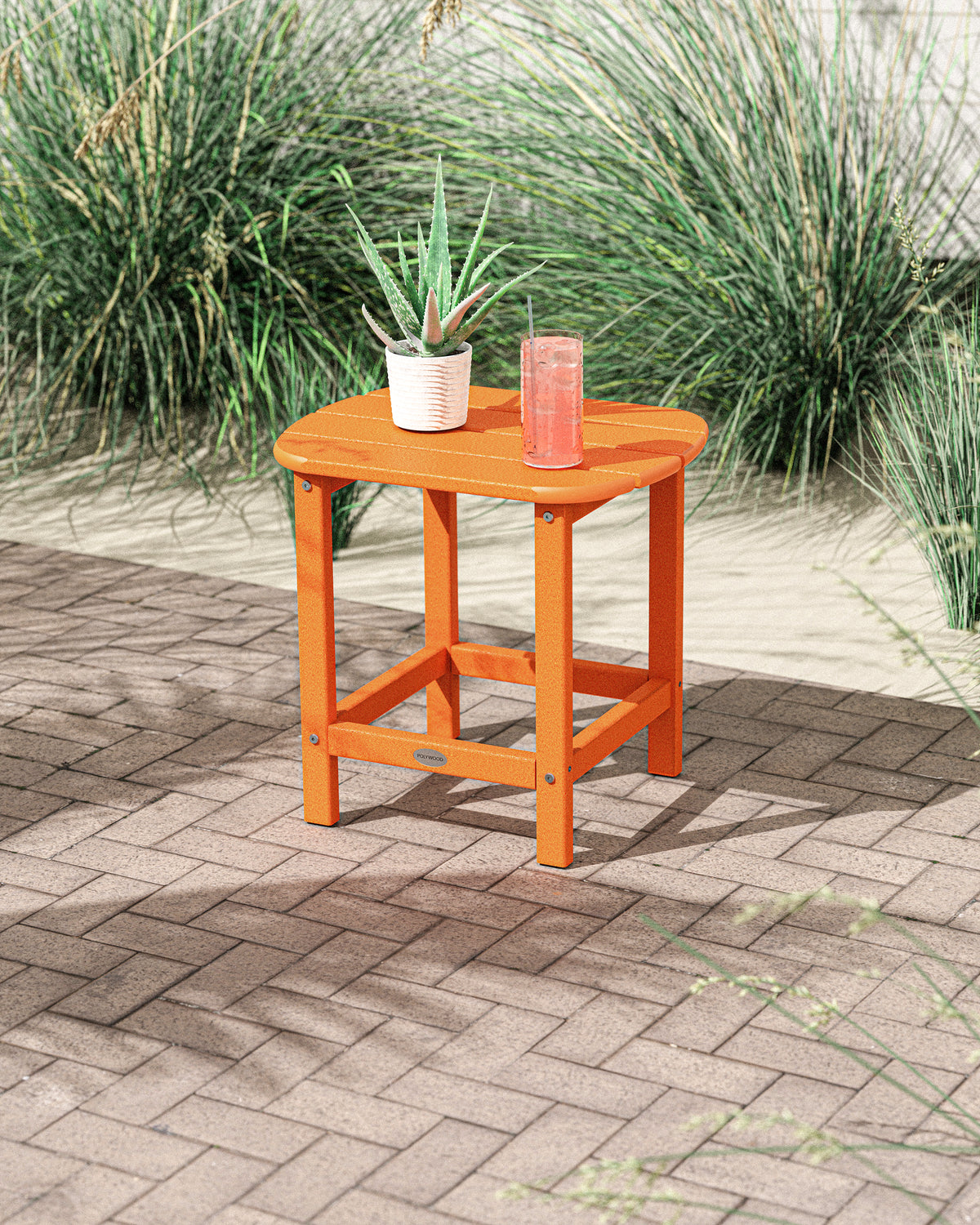 Lifestyle photo of the POLYWOOD South Beach 18" Side Table in Tangerine