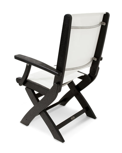 Rear angle view of the POLYWOOD Coastal Folding Chair in Black with a White sling
