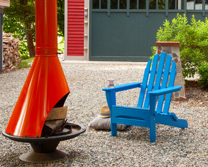 Lifestyle photo of the POLYWOOD Classic Folding Adirondack Chair in Pacific Blue