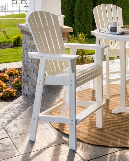 POLYWOOD Nautical Curveback Adirondack Bar Chair in White in an outdoor setting