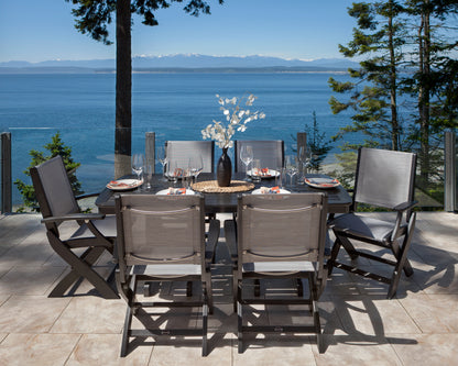 POLYWOOD Coastal Folding Chairs around a dining table on a waterfront terrace with mountain views
