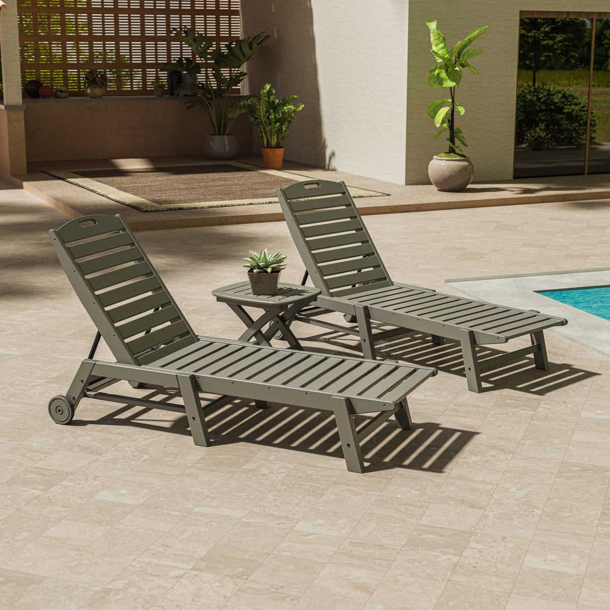 Lifestyle photo of the POLYWOOD Nautical 3-Piece Wheeled Chaise Set with Nautical Side Table in Slate Grey