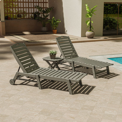 Lifestyle photo of the POLYWOOD Nautical 3-Piece Wheeled Chaise Set with Nautical Side Table in Slate Grey