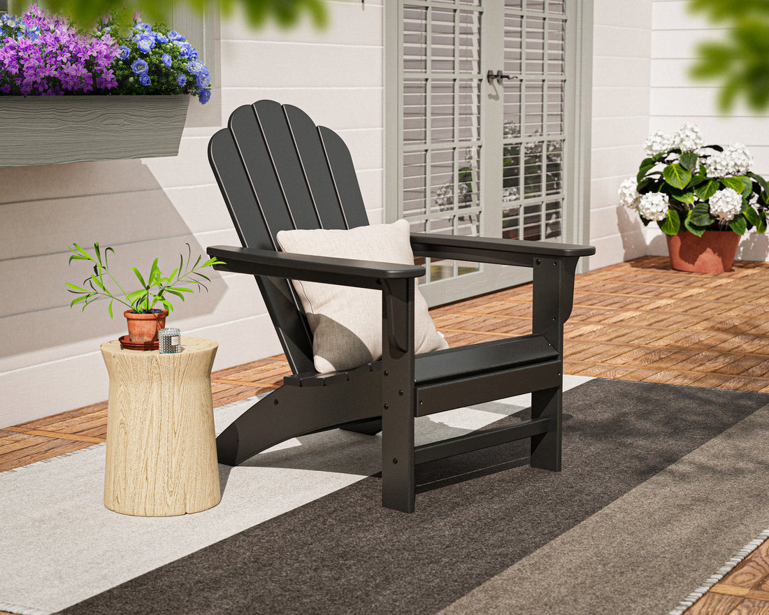 POLYWOOD Cottage Adirondack Chair in Black in an outdoor setting