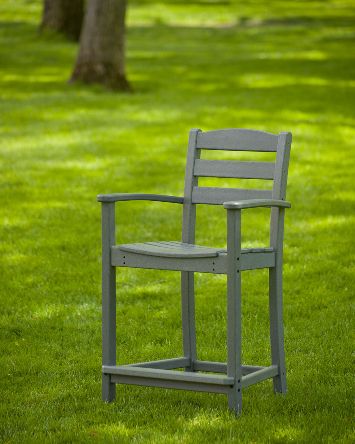 Lifestyle photo of the POLYWOOD La Casa Café Counter Arm Chair in Slate Grey