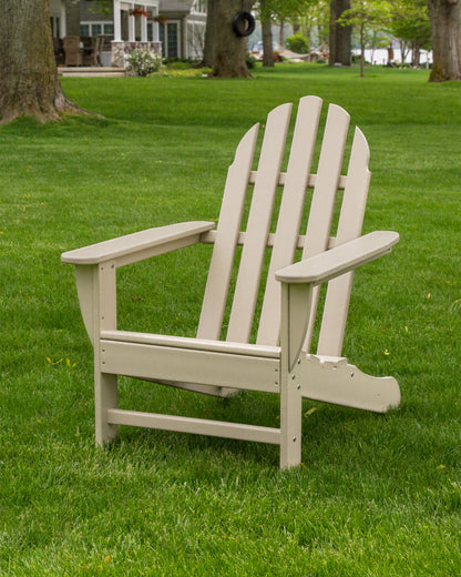 Lifestyle photo of the POLYWOOD Classic Adirondack Chair in Sand