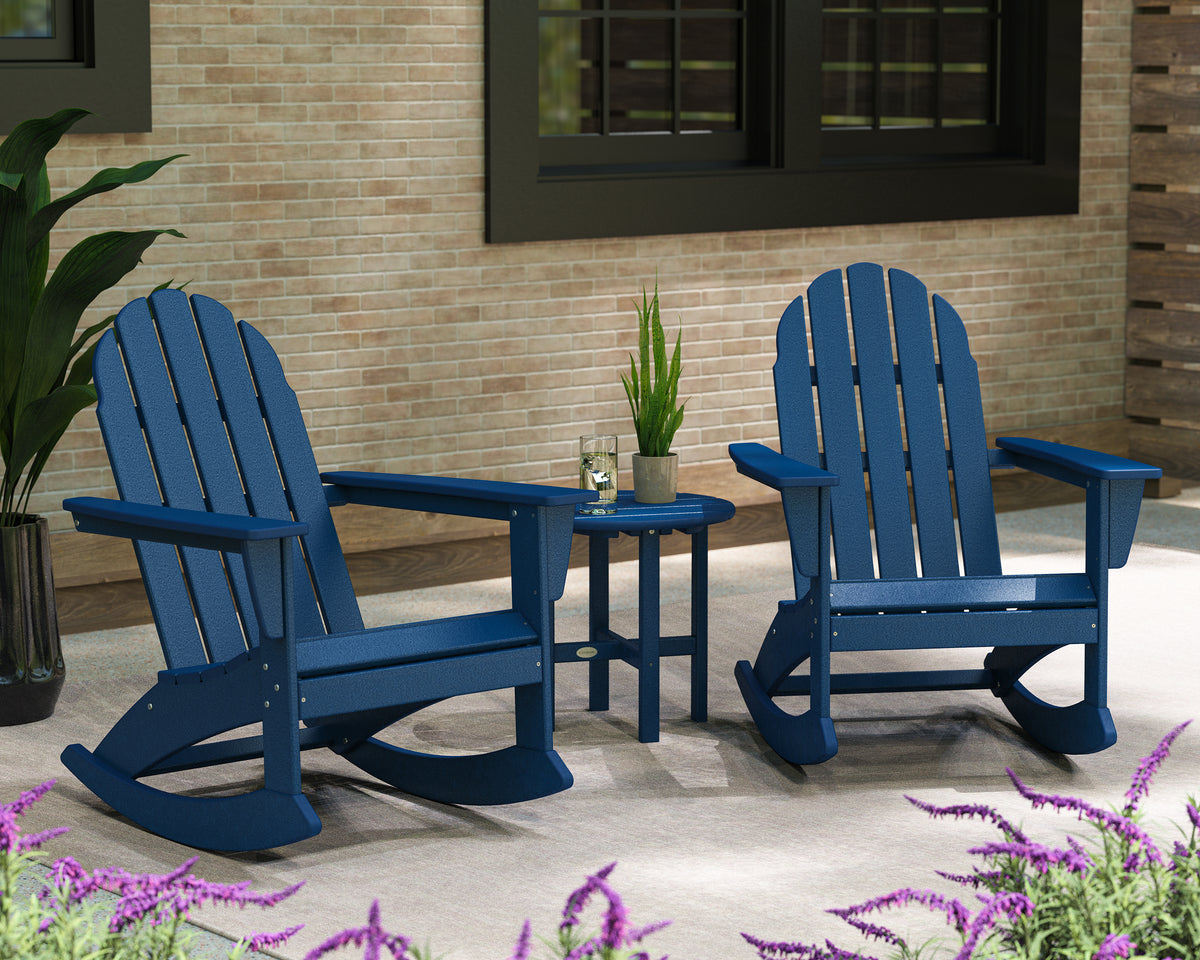 Lifestyle photo of the POLYWOOD Vineyard 3-Piece Adirondack Rocking Chair Set with 18" Round Table in Navy