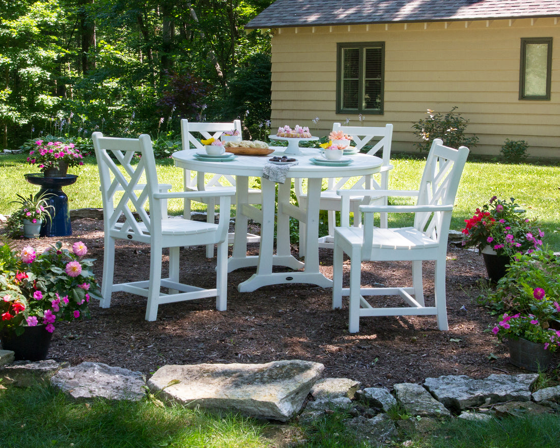 POLYWOOD Chippendale Dining Arm Chair in White in an outdoor setting