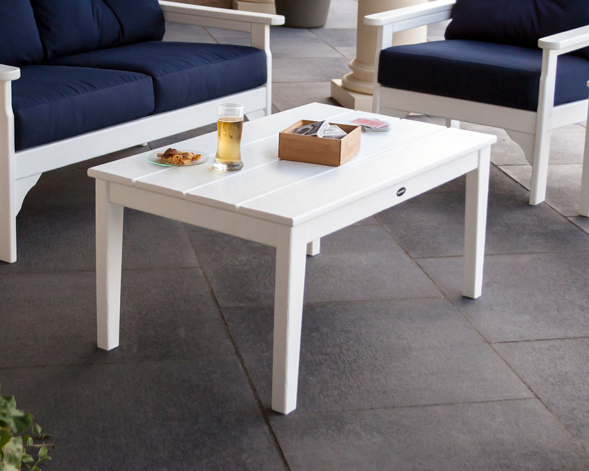 POLYWOOD Newport 22" x 36" Coffee Table in White on a stone patio with deep seating