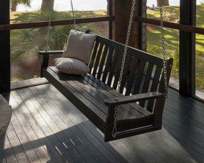 POLYWOOD Vineyard 60" Porch Swing in Black in an outdoor setting