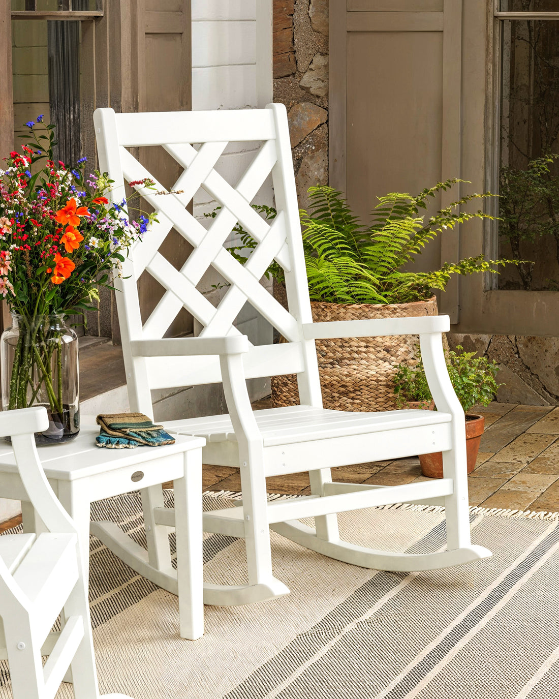 POLYWOOD Wovendale Rocking Chair in White in an outdoor setting