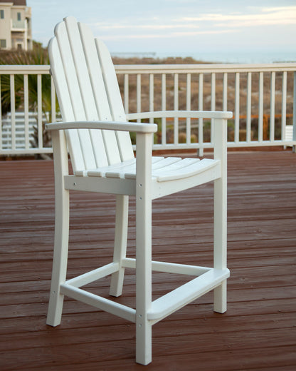 POLYWOOD Classic Adirondack Counter Chair in White in an outdoor setting