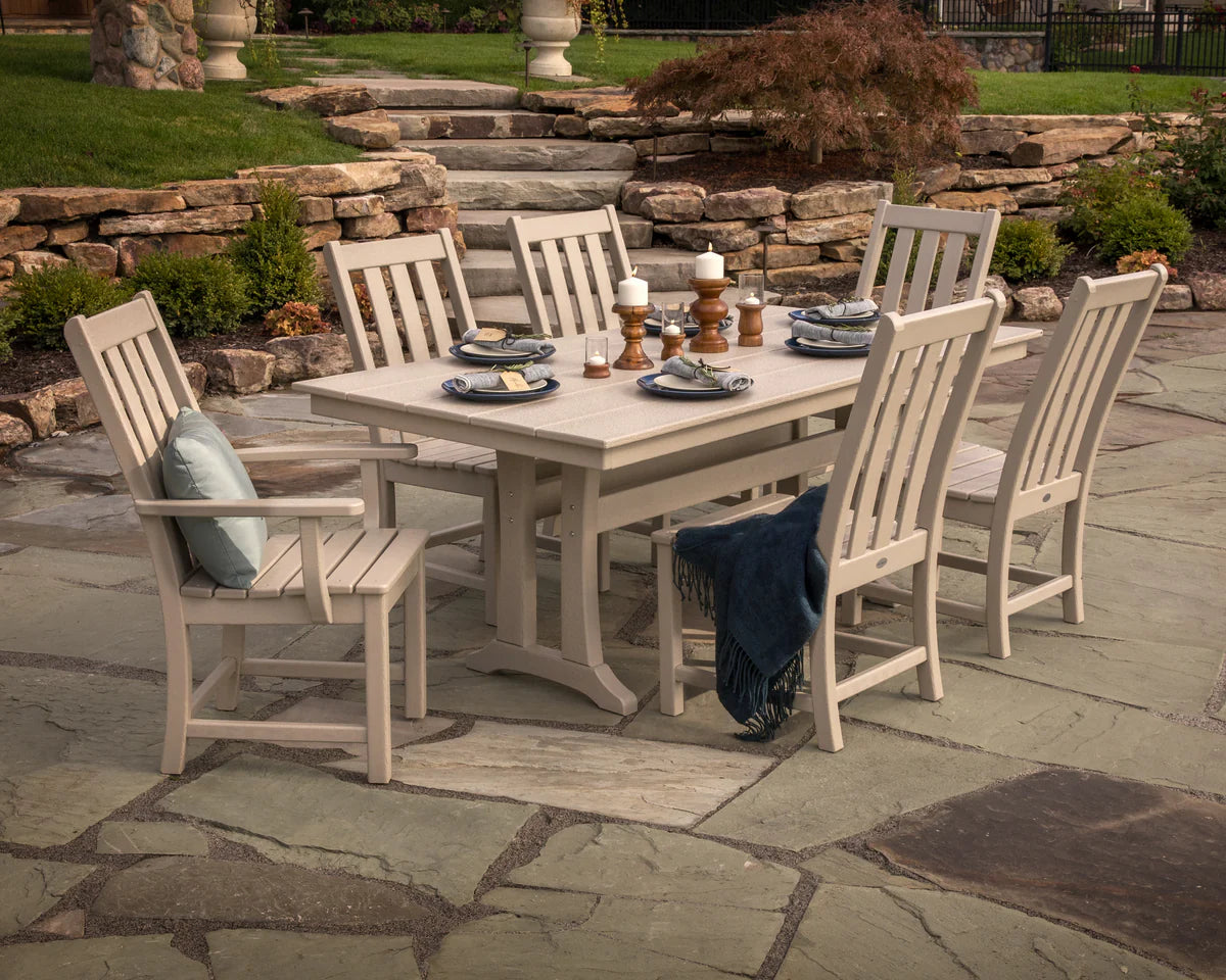 Outdoor dining set with table and chairs on a stone patio