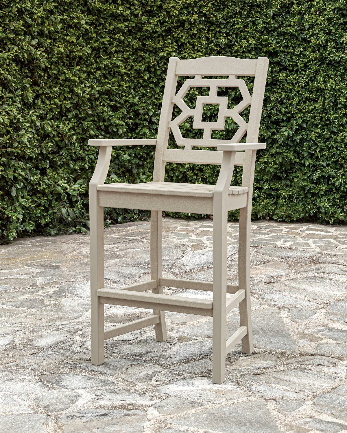 Lifestyle photo of the POLYWOOD Chinoiserie Bar Arm Chair in Sand