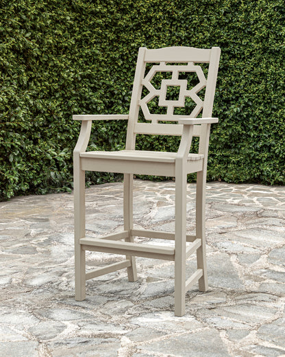 Lifestyle photo of the POLYWOOD Chinoiserie Bar Arm Chair in Sand