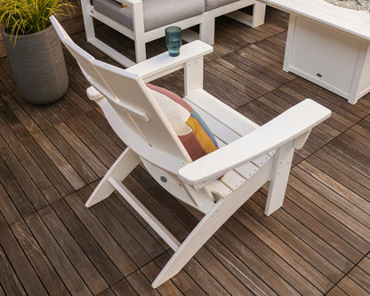 Lifestyle photo of the POLYWOOD Modern Grand Adirondack Chair in White